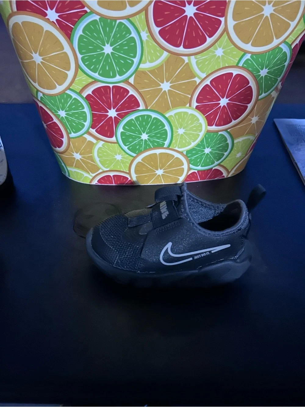 Nike Youth Black Slip-On Sneaker with White Swoosh and Blue Insole